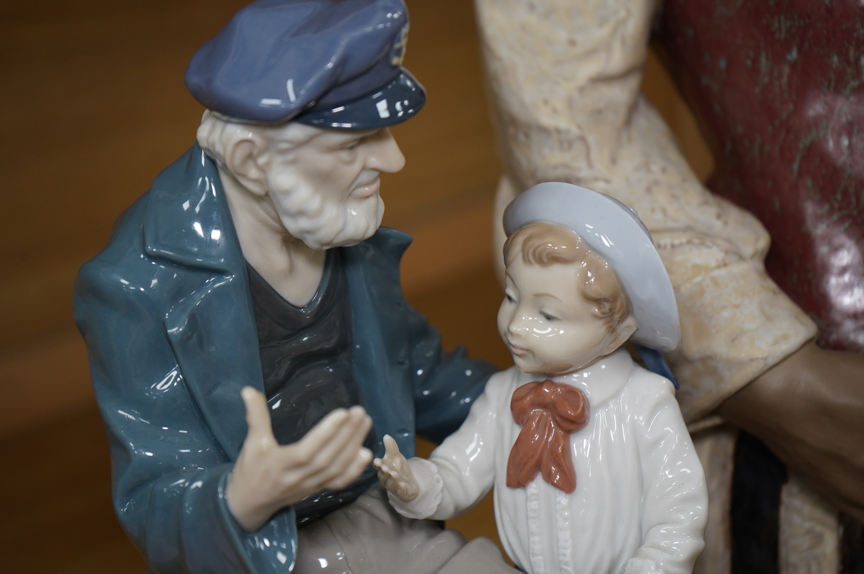 A Lladro figure ‘Playing the Blues’, 63cm high and a ‘Tall Yarn’ figure group of a fisherman and a boy. Condition - fisherman lacking the ship in his hand, otherwise good